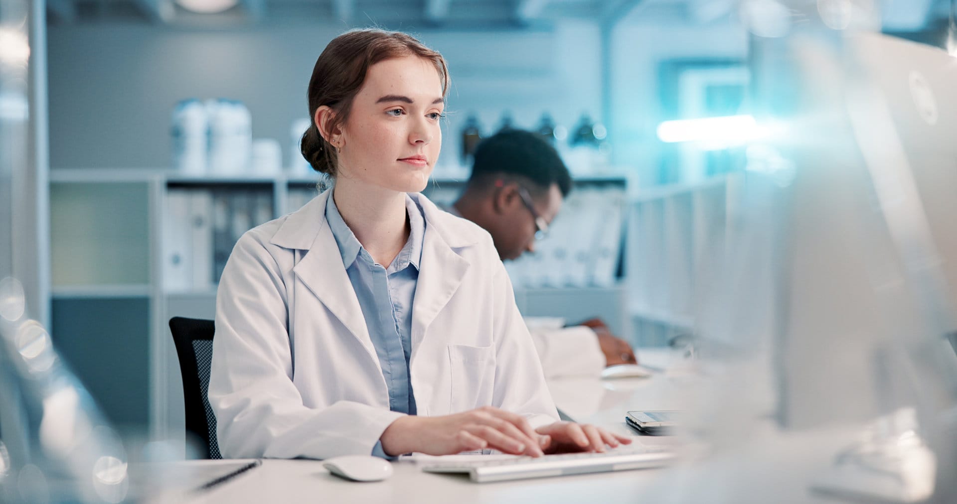 Computer, reading and woman in laboratory for research, development or science ideas. Online review, vaccine and female scientist on website for medical study, internship and biotech engineering