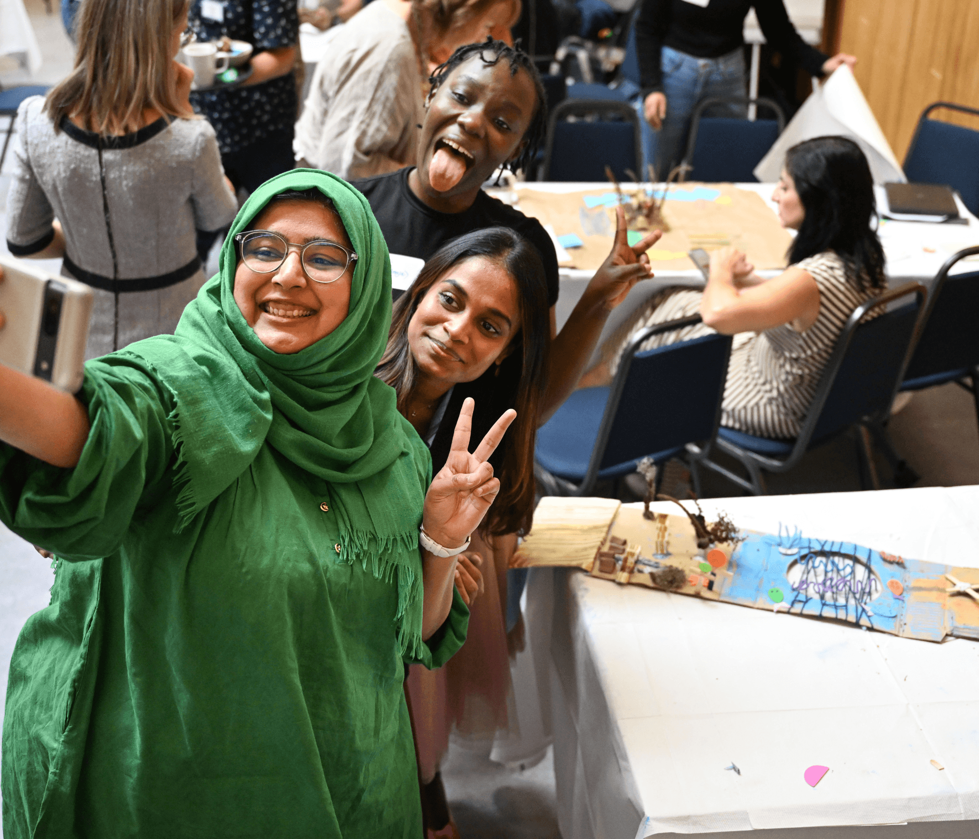 College student holding her robotic toy at robotics classroom at school